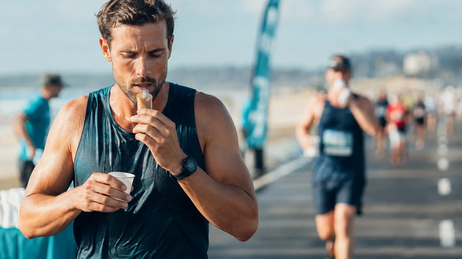 Runner taking an energy gel with water during a half marathon